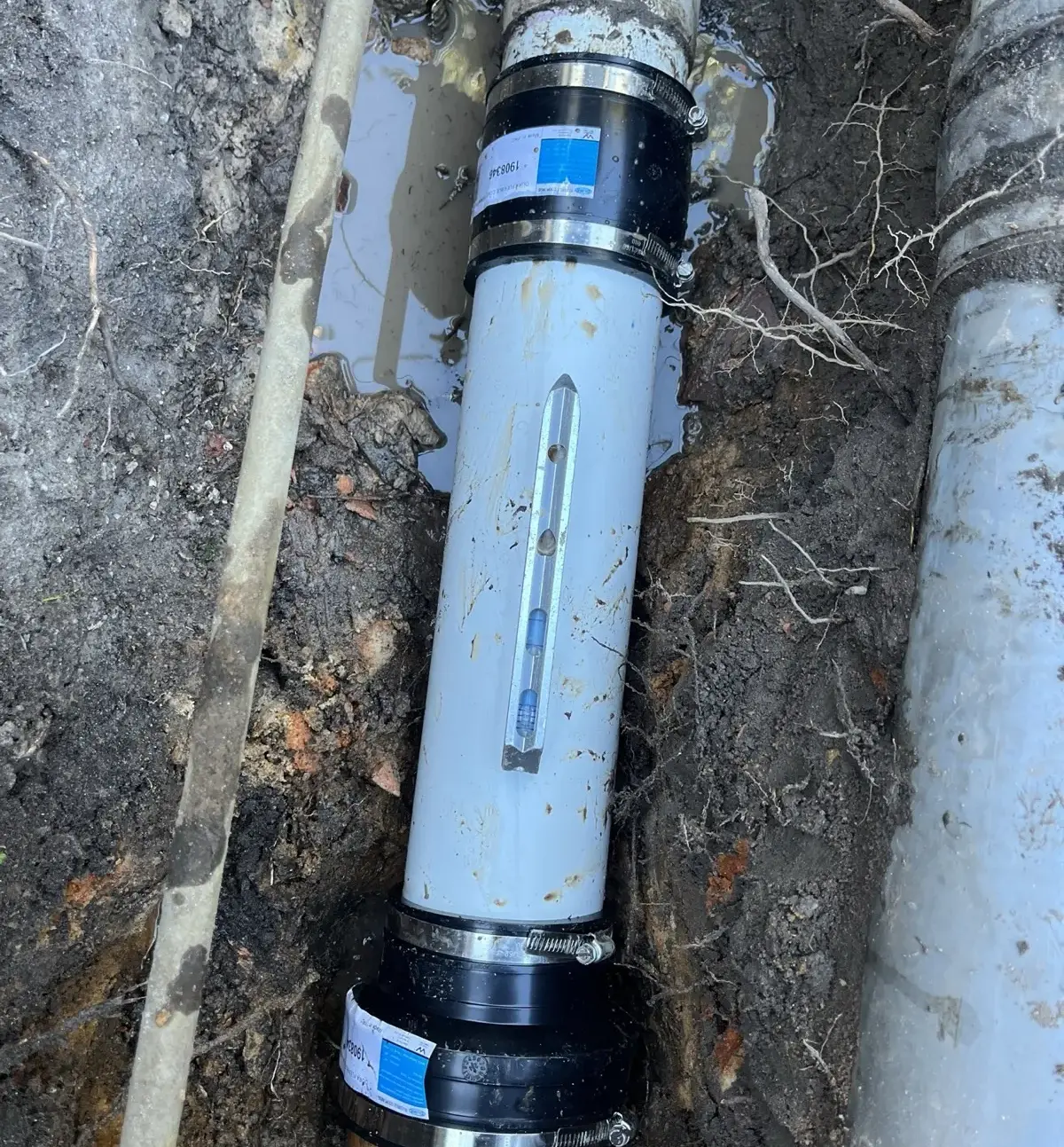 New drainage pipe section joined during an outdoor repair